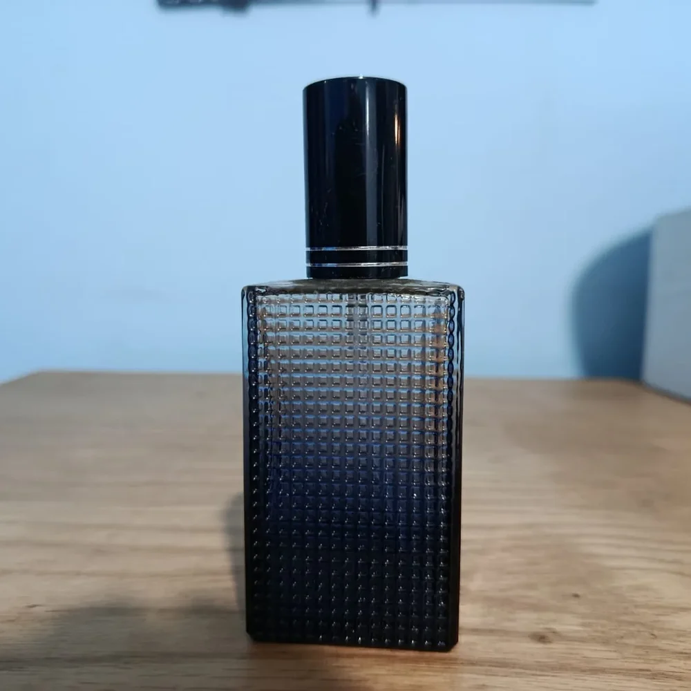 Textured grey glass perfume bottle — Input